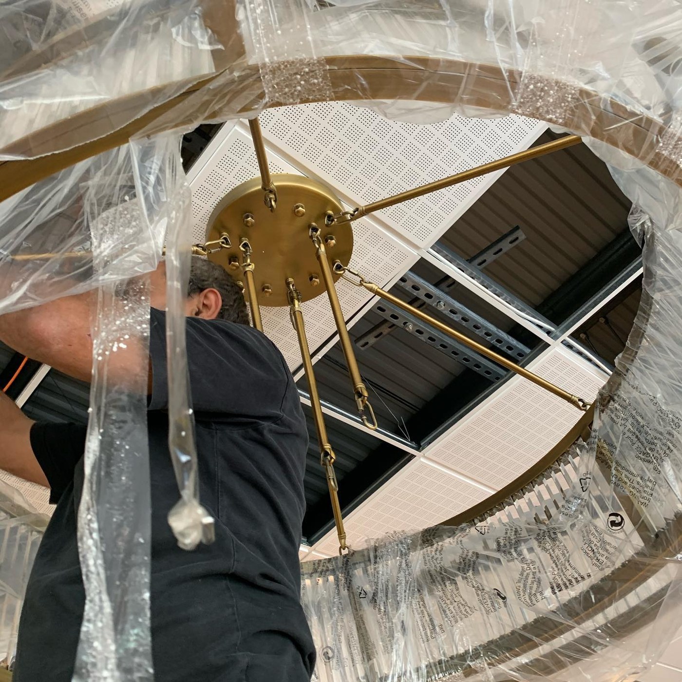 Ali installing a chandelier
